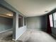 Gray living room with carpet, tile, and a view into another room at 11416 Belmont Lake Dr # 102, Las Vegas, NV 89135