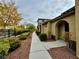 Sidewalk view of home with autumn trees and landscaping at 11416 Belmont Lake Dr # 102, Las Vegas, NV 89135