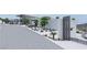 Modern house showcasing desert landscaping, a gated entrance, and a circular driveway at 1487 Reims Dr, Henderson, NV 89012