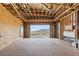 An unfinished interior featuring exposed framing, a fireplace, and a large sliding glass door with mountain views at 1487 Reims Dr, Henderson, NV 89012