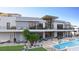 Luxury home boasts an outdoor living area with a pool, seating, and balconies at 1487 Reims Dr, Henderson, NV 89012