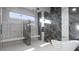 Bathroom showcasing a glass-enclosed shower with dual shower heads and tiled walls at 1487 Reims Dr, Henderson, NV 89012