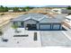 Single-story home with three-car garage and desert landscaping at 1691 Blackhorn St, Pahrump, NV 89048