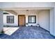 Covered entryway with a modern wood front door and tile flooring at 1691 Blackhorn St, Pahrump, NV 89048