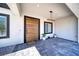 Modern entryway with a wood front door and stylish light fixture at 1691 Blackhorn St, Pahrump, NV 89048