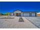 Modern single-story house with a three-car garage and desert landscaping at 1691 Blackhorn St, Pahrump, NV 89048