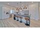 Modern kitchen with white cabinets, an island with seating, and stainless steel appliances at 1691 Blackhorn St, Pahrump, NV 89048