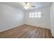 Bedroom with ceiling fan, wood-look flooring, window shutters and an open closet at 204 Orland St # 2, Las Vegas, NV 89107