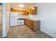 Compact kitchen featuring wooden cabinets, a white refrigerator, and tiled floors at 204 Orland St # 2, Las Vegas, NV 89107