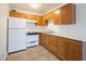 Bright kitchen featuring light wood cabinets, white appliances, and tile flooring at 204 Orland St # 2, Las Vegas, NV 89107