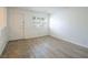 Bright living room featuring two-toned flooring, plantation shutters and white walls at 204 Orland St # 2, Las Vegas, NV 89107