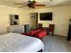 Bedroom with king bed, red chaise lounge, and TV at 4951 Schumann Dr, Las Vegas, NV 89146