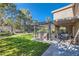 Landscaped backyard with a pergola and patio furniture at 5205 Sandy Cactus Ln, Las Vegas, NV 89149