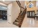 Grand entryway with a sweeping staircase and high ceilings at 5205 Sandy Cactus Ln, Las Vegas, NV 89149