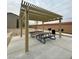 Outdoor picnic area featuring a shade structure, picnic tables, and barbeque grills at 6680 Nimbus Ave # Lot 20, Las Vegas, NV 89130