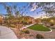 Landscaped community area with a grassy lawn and pathway at 11712 Emerald Lake Ave, Las Vegas, NV 89138