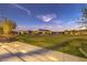 Large community park with grassy areas, lighting and seating at 11712 Emerald Lake Ave, Las Vegas, NV 89138