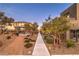 Pathway through landscaped community with a covered seating area at 11712 Emerald Lake Ave, Las Vegas, NV 89138