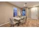 Elegant dining room features a marble table and six light-grey cushioned chairs at 11712 Emerald Lake Ave, Las Vegas, NV 89138