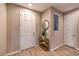 Bright entryway with tile flooring, a coat closet, and a stylish gold and wood shelf at 11712 Emerald Lake Ave, Las Vegas, NV 89138