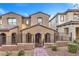 Two-story home with modern facade, brick accents, and gated entry at 11712 Emerald Lake Ave, Las Vegas, NV 89138