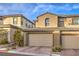 Tan two story home with a two car garage and landscaping at 11712 Emerald Lake Ave, Las Vegas, NV 89138