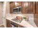 Modern kitchen features a gas cooktop, microwave, and white hexagonal backsplash at 11712 Emerald Lake Ave, Las Vegas, NV 89138