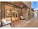 Private patio with brick pavers, seating area, and glass doors leading to interior at 11712 Emerald Lake Ave, Las Vegas, NV 89138