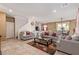 Spacious living room with tiled floors and comfy gray sofas at 2815 Donatello Manor Pl, Henderson, NV 89044