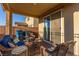 Relaxing covered patio with wicker furniture and a small table at 2815 Donatello Manor Pl, Henderson, NV 89044