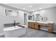Modern bathroom featuring a soaking tub, sleek vanity, and a minimalist design aesthetic at 3531 W Arby Ave, Las Vegas, NV 89118