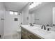 Modern bathroom featuring a double vanity with elegant countertops, sleek fixtures, and stylish tiled shower/tub combo at 3531 W Arby Ave, Las Vegas, NV 89118