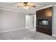 Spacious bedroom boasts soft carpeting, a dark wood accent wall with a cozy fireplace, and neutral walls at 3531 W Arby Ave, Las Vegas, NV 89118