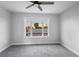 Bright bedroom with plush carpet, large window offering serene views, and contemporary ceiling fan for comfort at 3531 W Arby Ave, Las Vegas, NV 89118