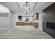 Open concept kitchen with modern light fixture, wood cabinets, fireplace, and abundant counter space at 3531 W Arby Ave, Las Vegas, NV 89118