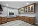 Gourmet kitchen with custom cabinetry, white countertops, stylish backsplash, and a built-in bench at 3531 W Arby Ave, Las Vegas, NV 89118