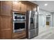 Gourmet kitchen features stainless steel appliances and custom wood cabinetry at 3531 W Arby Ave, Las Vegas, NV 89118