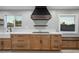 Modern kitchen featuring custom cabinets, a farmhouse sink, and stainless steel appliances at 3531 W Arby Ave, Las Vegas, NV 89118