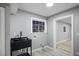 Modern laundry room featuring sleek black utility sink, stylish fixtures, and ample natural light from bright windows at 3531 W Arby Ave, Las Vegas, NV 89118