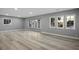 Spacious living area with luxury vinyl plank flooring, large windows providing ample natural light, freshly painted walls at 3531 W Arby Ave, Las Vegas, NV 89118