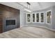 Sunlit living room with a wood accent wall, modern fireplace, and large windows at 3531 W Arby Ave, Las Vegas, NV 89118