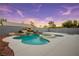 Private outdoor oasis featuring a luxurious pool, spa, and rock waterfall feature at 3531 W Arby Ave, Las Vegas, NV 89118