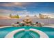 Inviting backyard pool features a rock waterfall, integrated spa, and surrounding patio, great for outdoor relaxation at 3531 W Arby Ave, Las Vegas, NV 89118