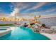 Sparkling pool featuring rock waterfall and lush landscaping at 3531 W Arby Ave, Las Vegas, NV 89118