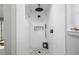 Contemporary shower featuring white tiling, a rainfall shower head, and a mosaic tile floor at 3531 W Arby Ave, Las Vegas, NV 89118