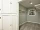 Organized walk-in closet with custom storage, ample shelving, and natural light from a small window at 3531 W Arby Ave, Las Vegas, NV 89118