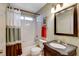 Clean bathroom with tub, shower, and dark vanity at 6143 Basilone Ave, Las Vegas, NV 89122