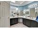 Double vanity bathroom with light blue walls and dark cabinets at 6143 Basilone Ave, Las Vegas, NV 89122