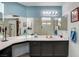 Double vanity bathroom with light blue walls and dark cabinets at 6143 Basilone Ave, Las Vegas, NV 89122