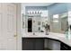 Double vanity bathroom with light blue walls and dark cabinets at 6143 Basilone Ave, Las Vegas, NV 89122